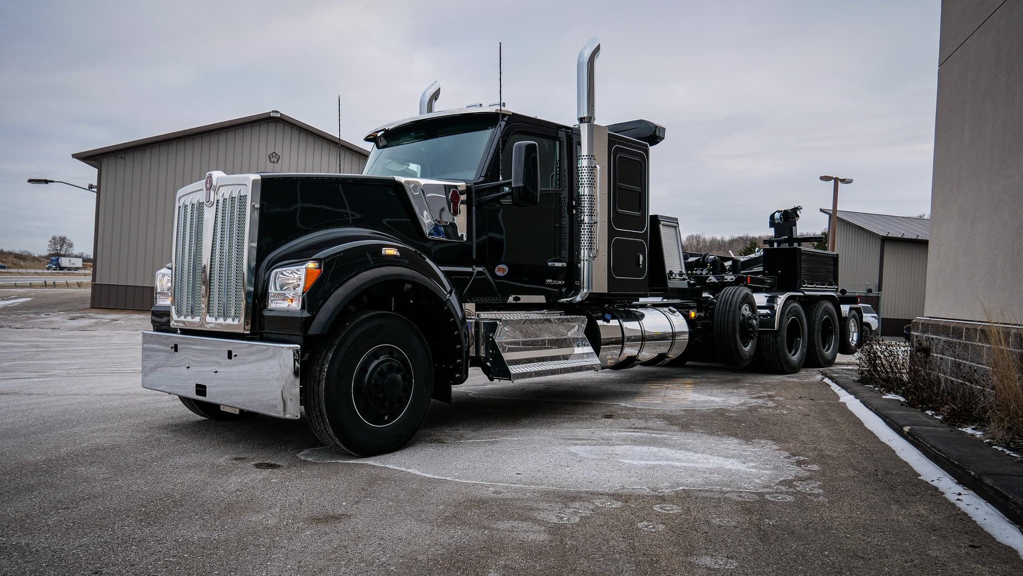 Black Kenworth heavy-duty chassis with recovery equipment and chrome trim