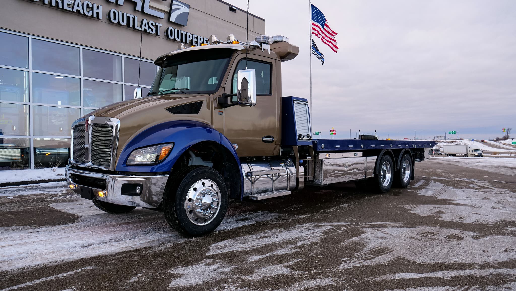 Kenworth rollback in bronze and blue two-tone paint with chrome accents